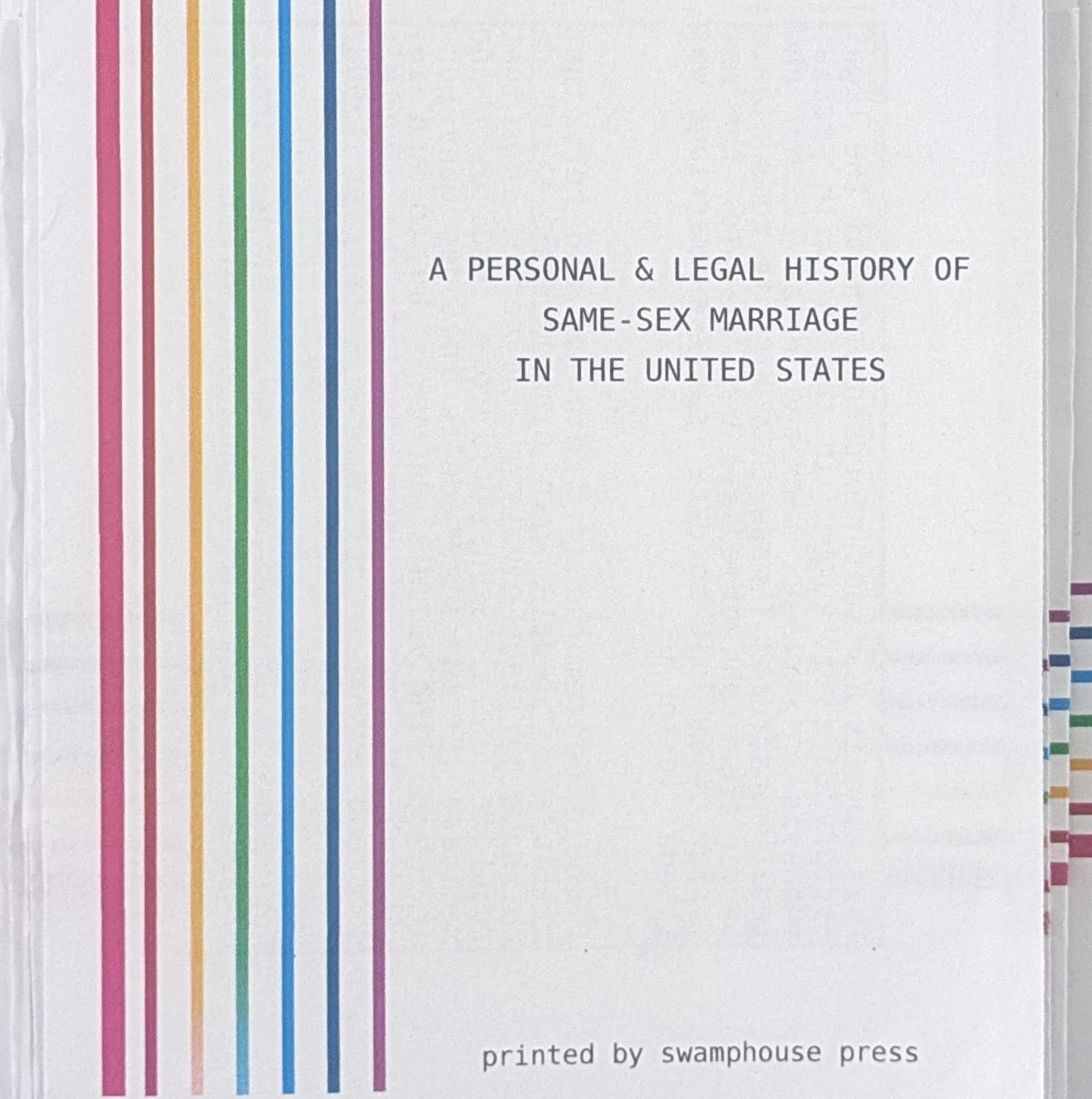 The cover of the zine “A Personal and Legal History of Same Sex Marriage in the United States.” The text of the title is next to a series of rainbow-colored lines.