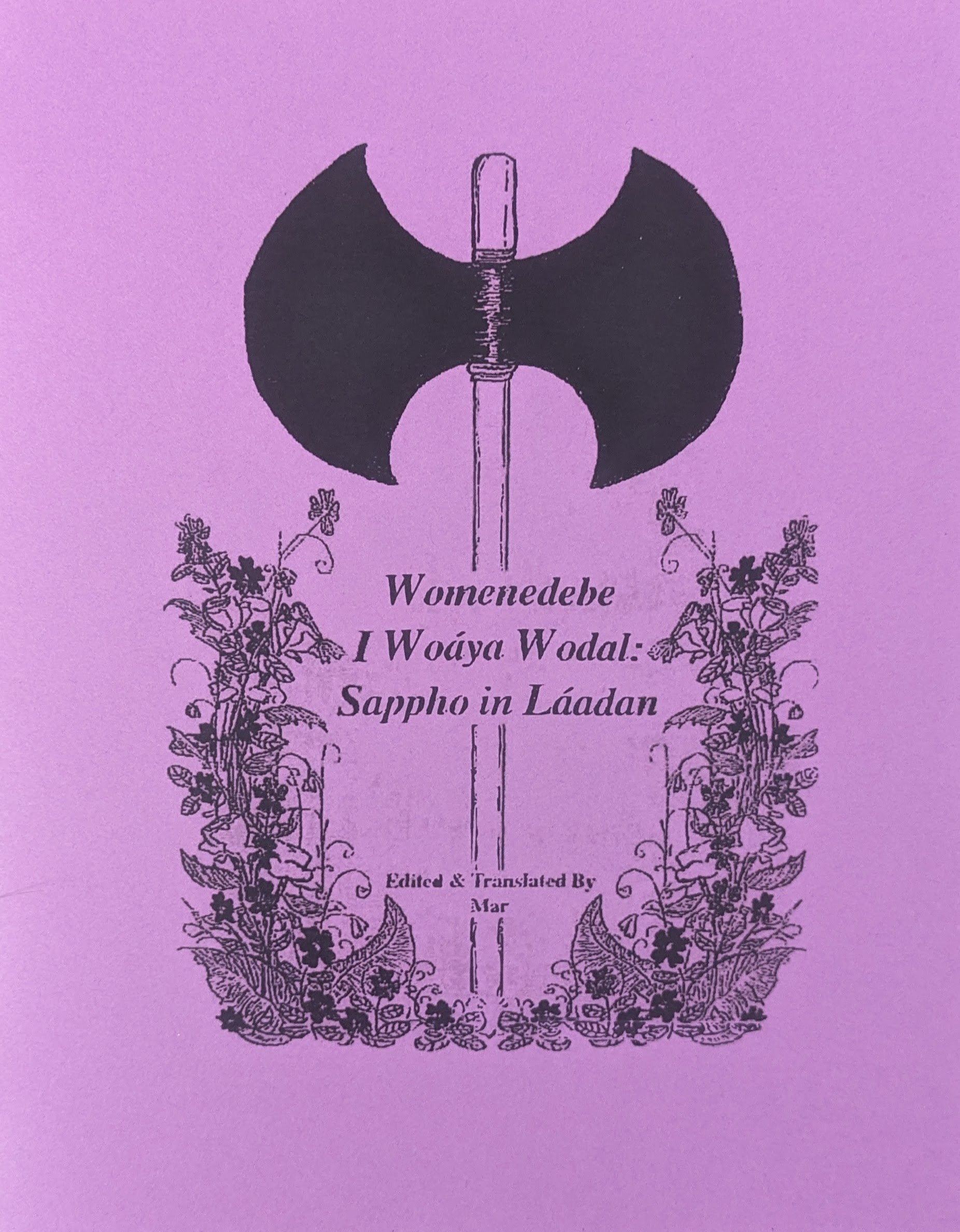 The cover of the zine “Sappho in Laadan.” An illustration of the labrys lesbian flag surrounded by flowers.