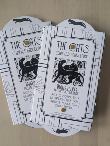 The cover of the zine “The Cats.” An illustration of two panthers in an Art Deco style including a list of translators who have translated the poem.